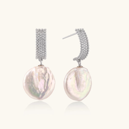 Rhodium-plated silver curved stud with pave stones and baroque pearl drop on white background