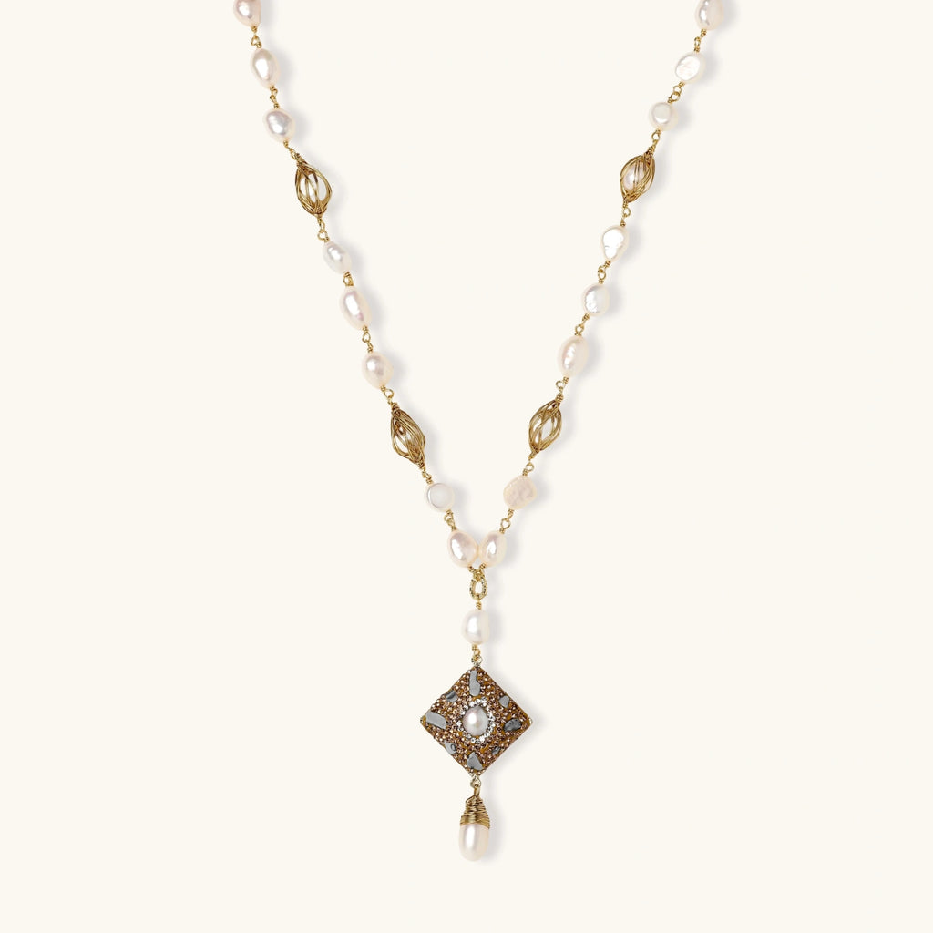 Y-shaped necklace with freshwater pearls, gold filigree stations, and ornate diamond-shaped centerpiece with pearl drop